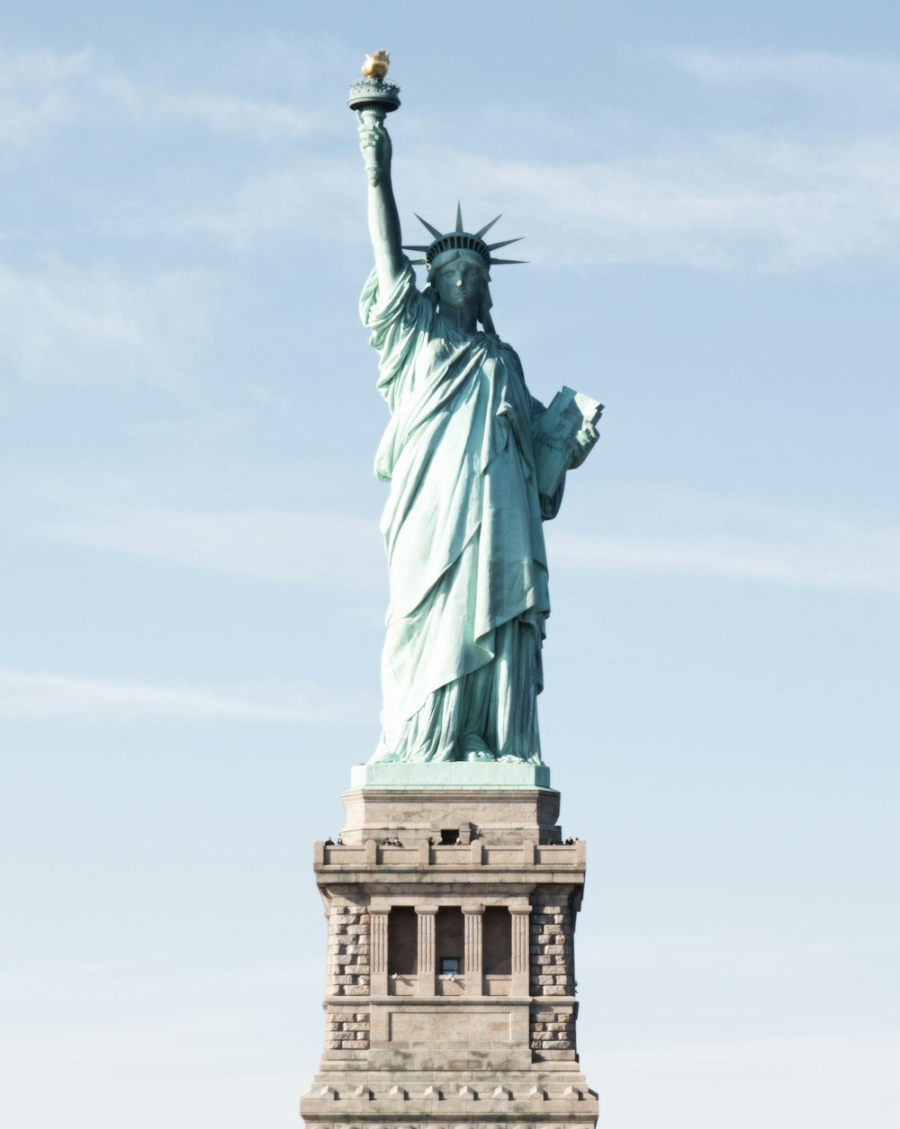 the statue of liberty is shown against a blue sky