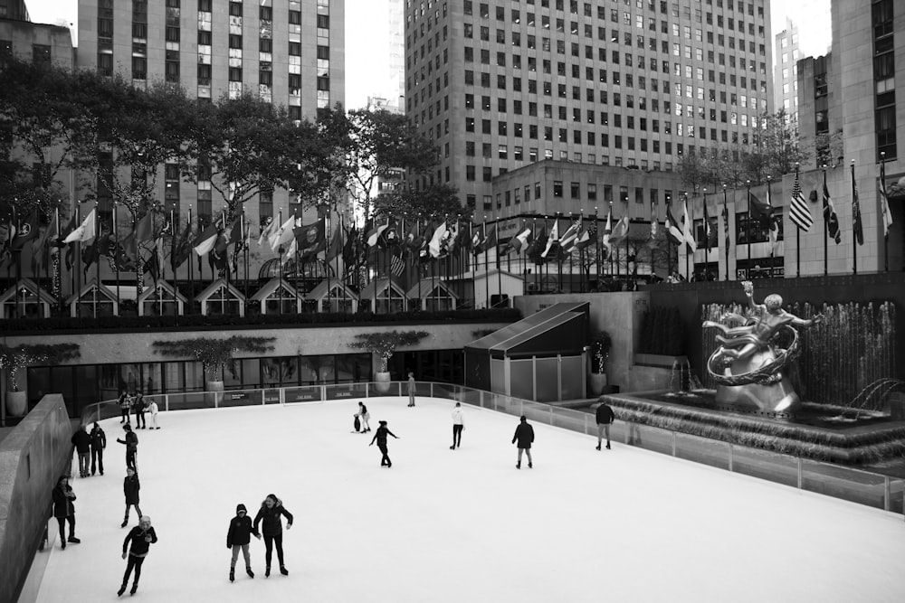 a group of people skating on an ice rink