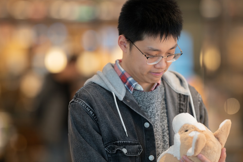 a man holding a stuffed animal in his hands
