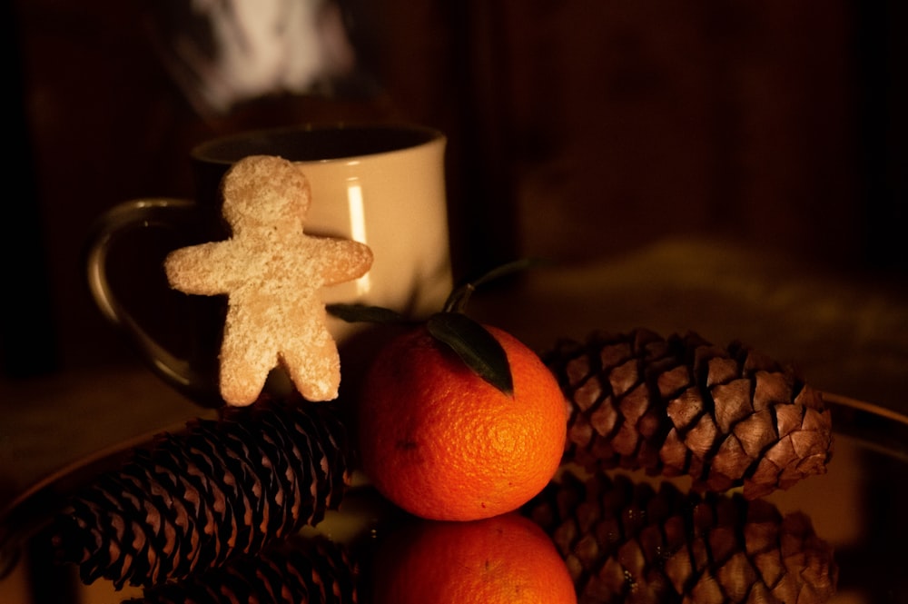 two oranges and a gingerbread man on a plate