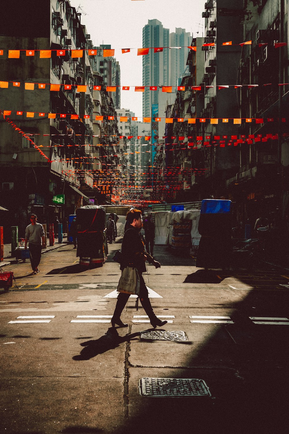 a person crossing a street in a city