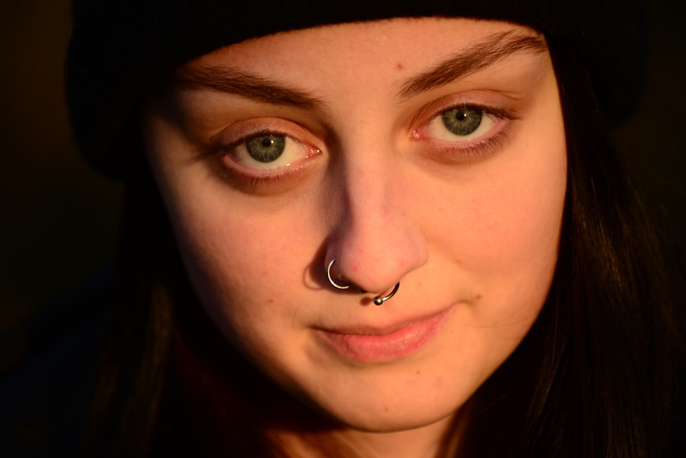 a woman with a nose piercing on her nose