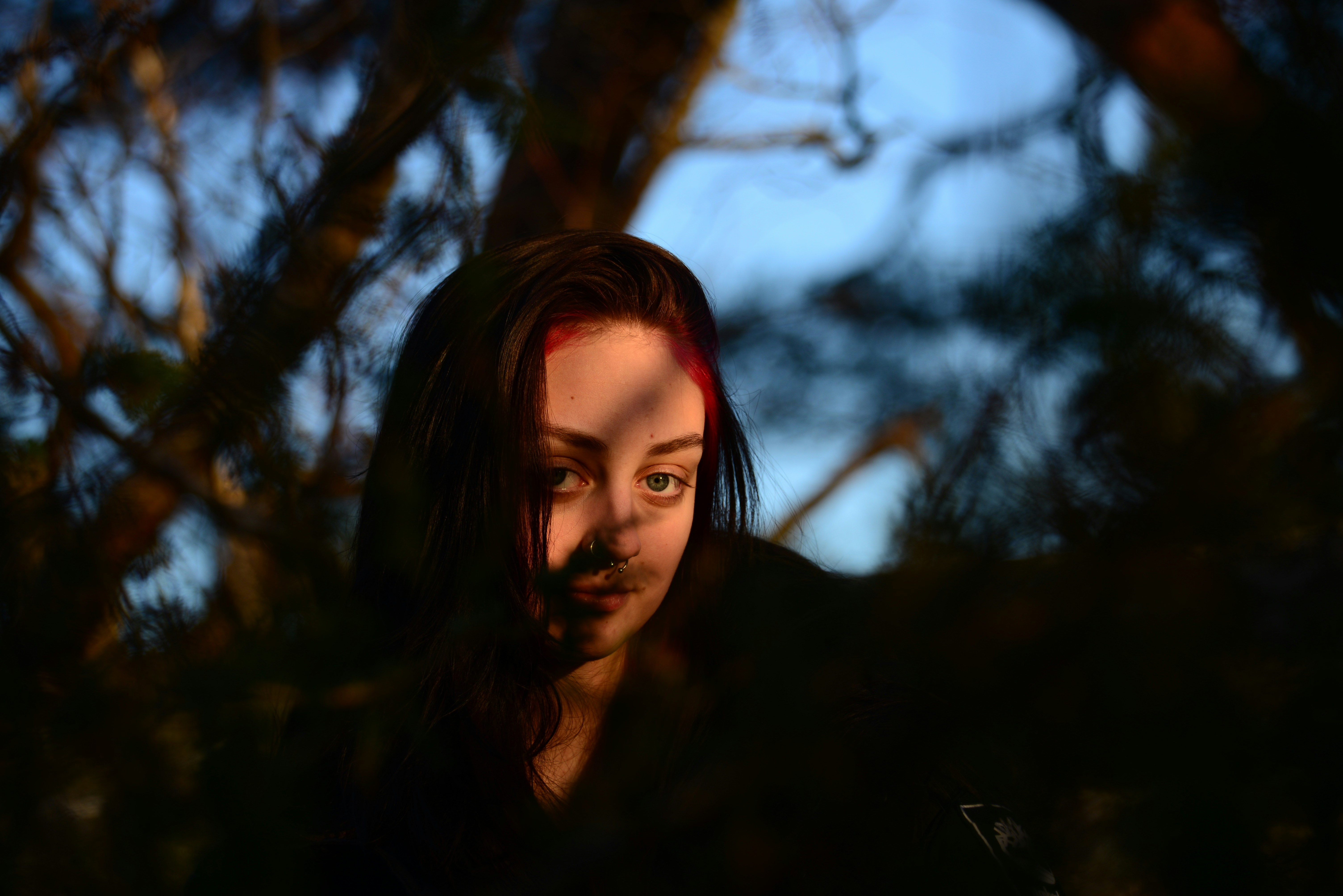 a woman with red hair is looking at the camera