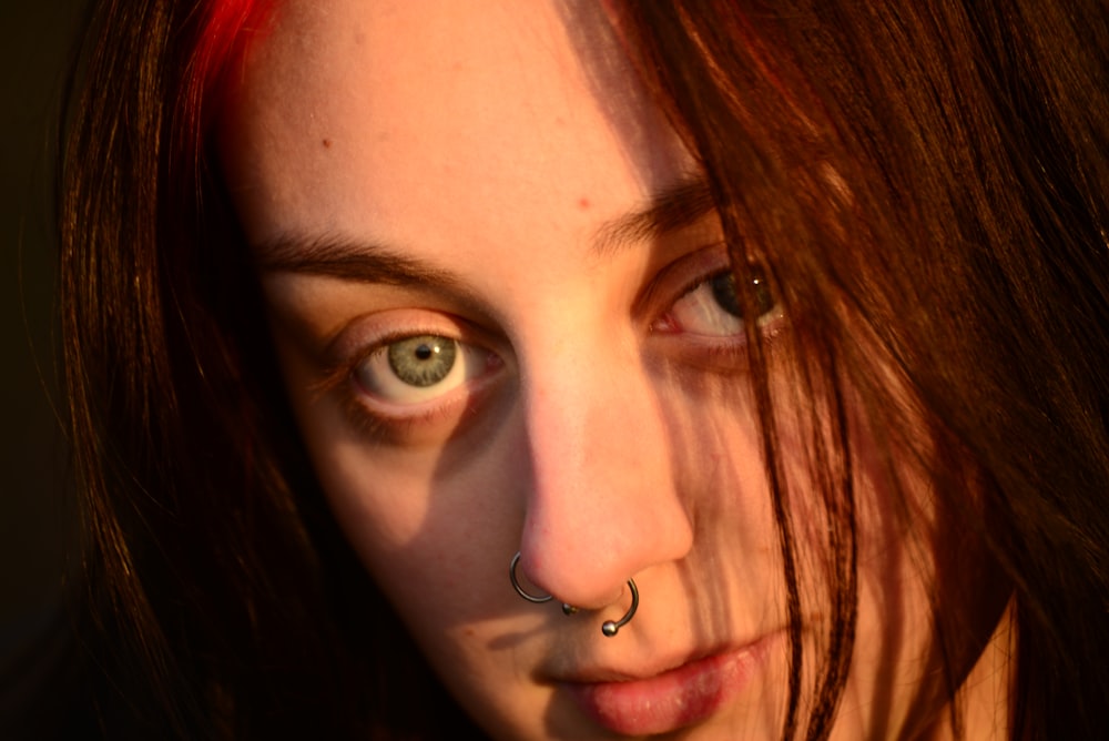 a woman with a nose ring and piercing on her nose