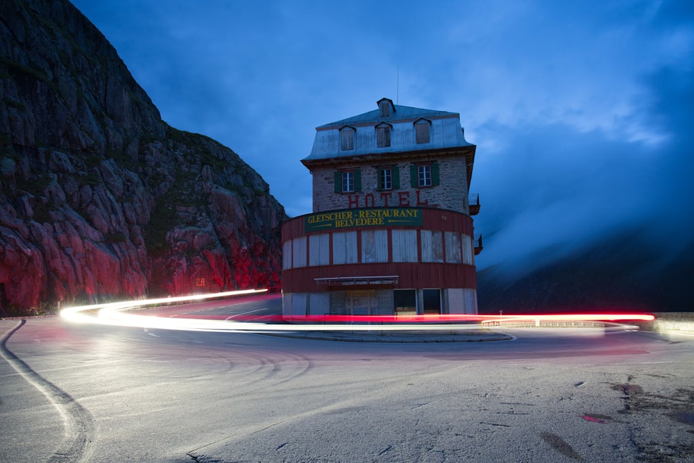 a red and white building sitting on the side of a road