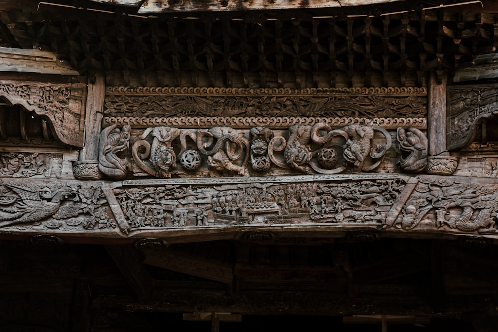 a close up of a wooden carving on a building