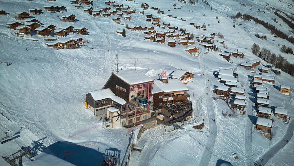 an aerial view of a village in the snow
