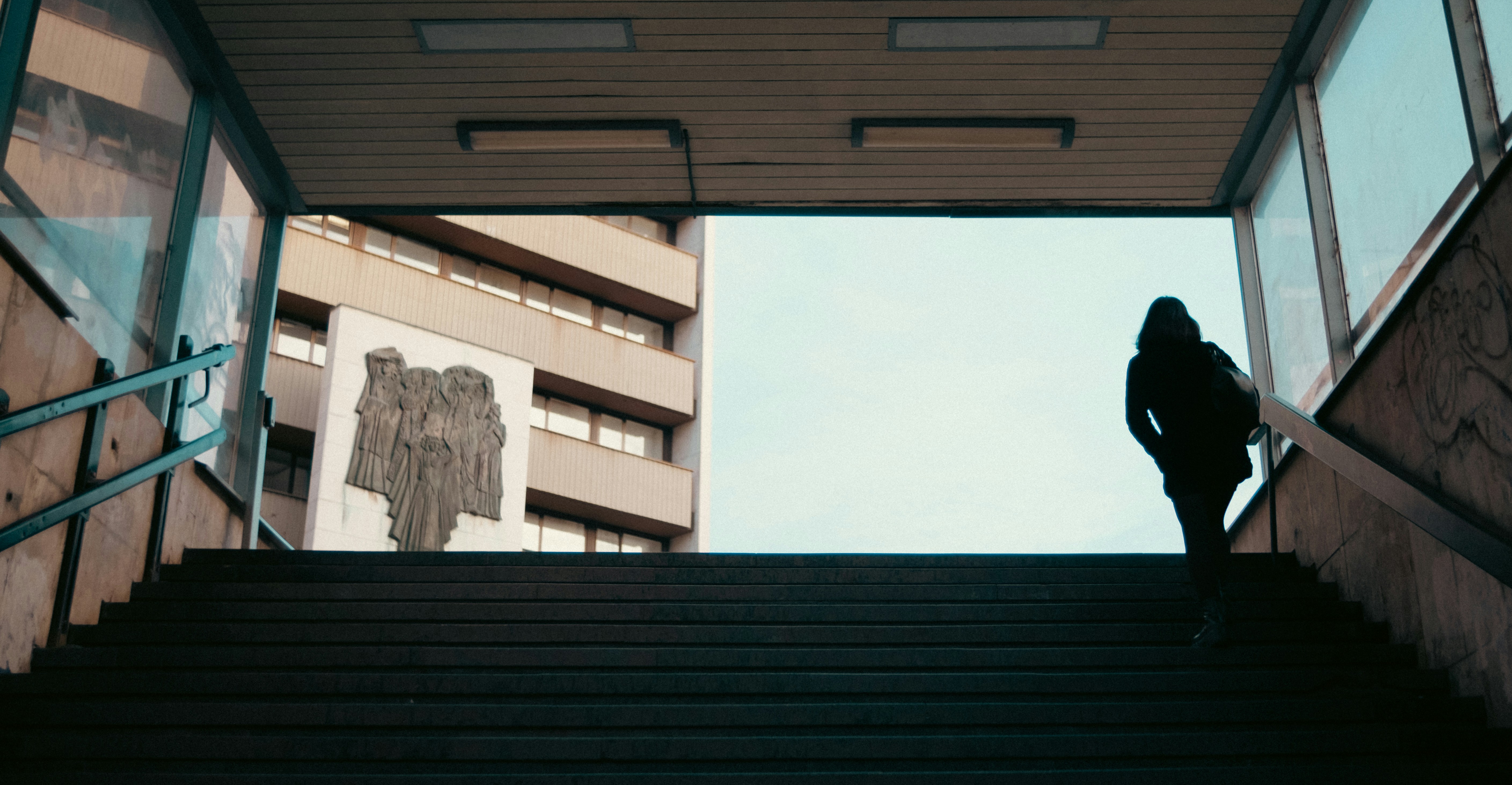 a person standing on a set of stairs in front of a building