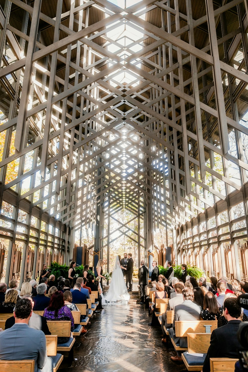 a bride and groom are walking down the aisle of a church