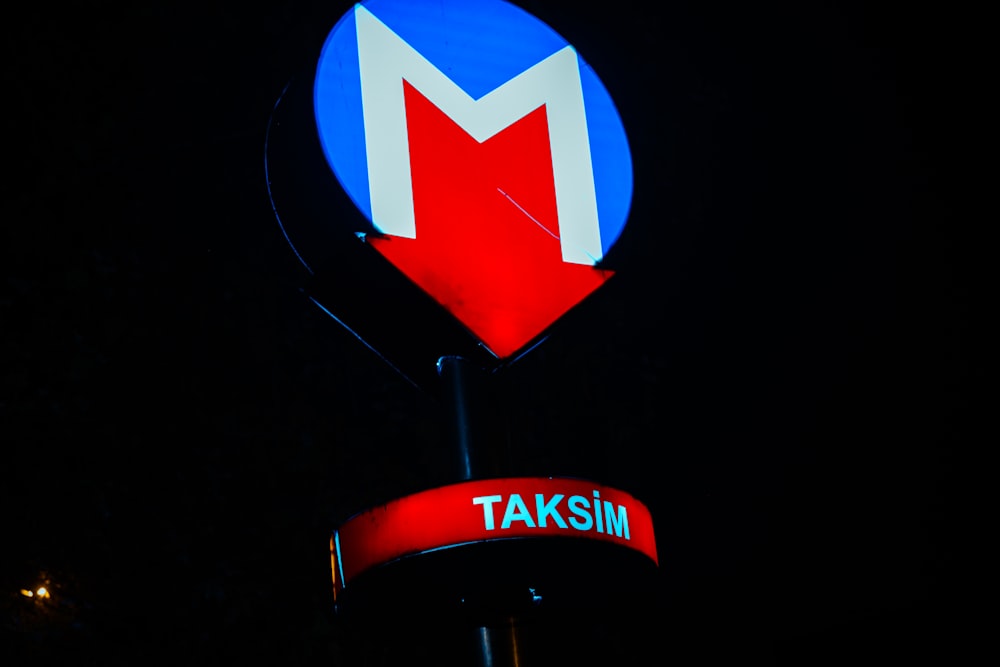 a red, white and blue sign that says taksim