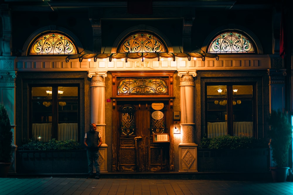 the front of a building lit up at night