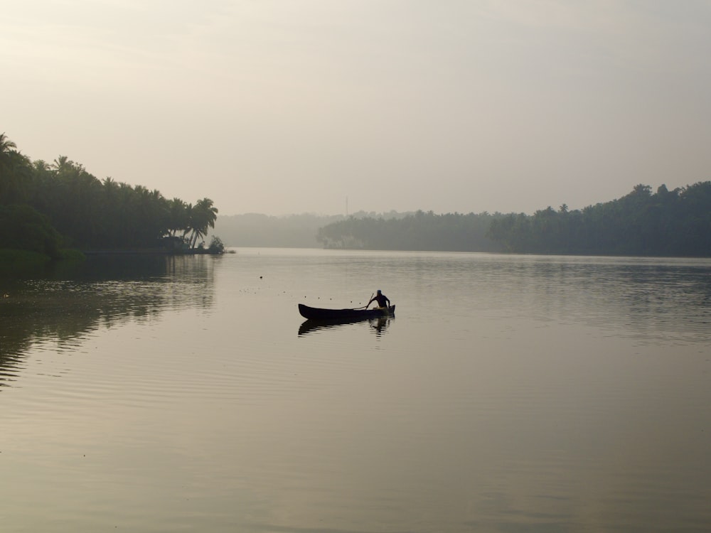 a person in a canoe on a lake