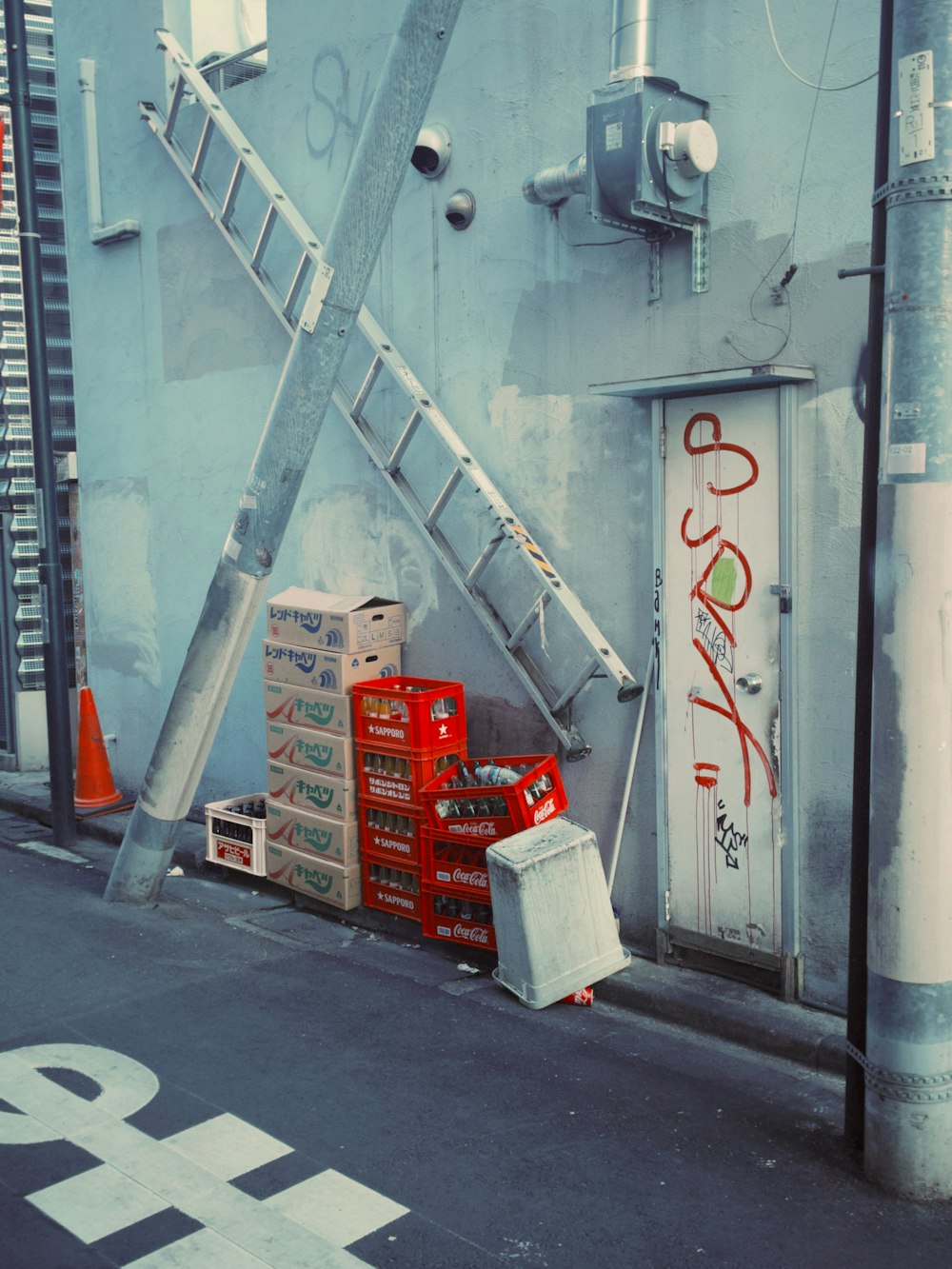 a ladder leaning up against a wall next to boxes