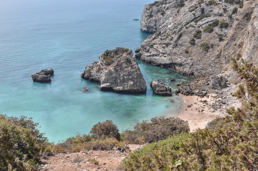 a view of a rocky beach with clear blue water