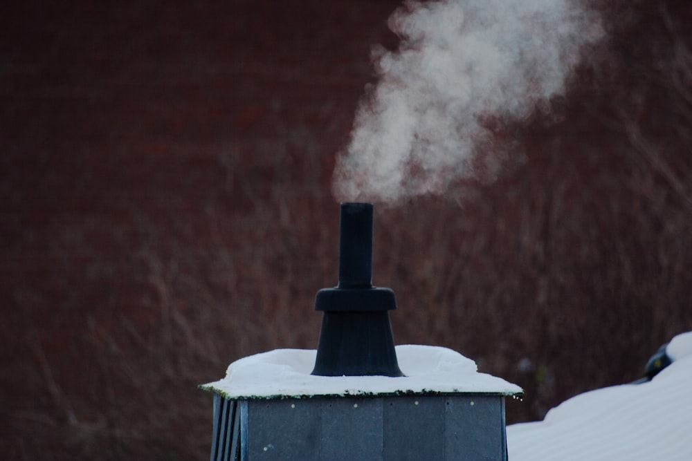 smoke coming out of a chimney in the snow