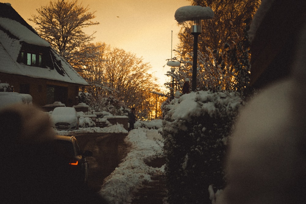 a snow covered street next to a building