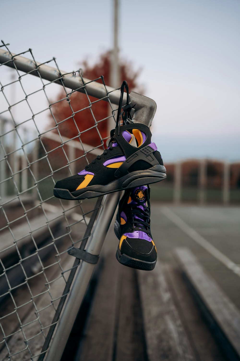 a pair of shoes hanging on a fence