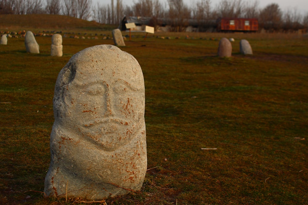 a large stone with a face carved into it