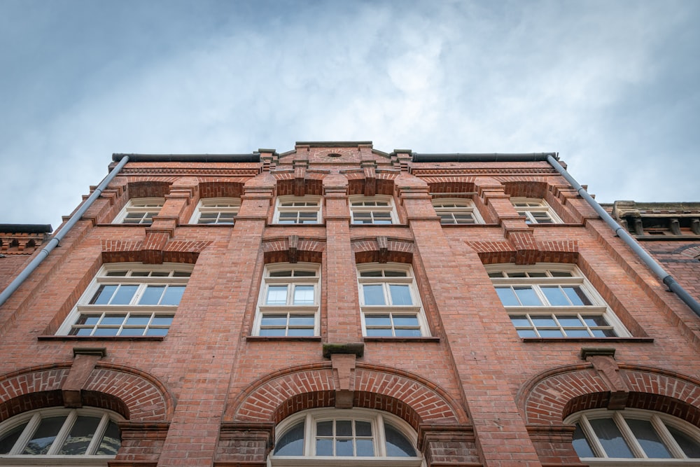 a tall red brick building with arched windows