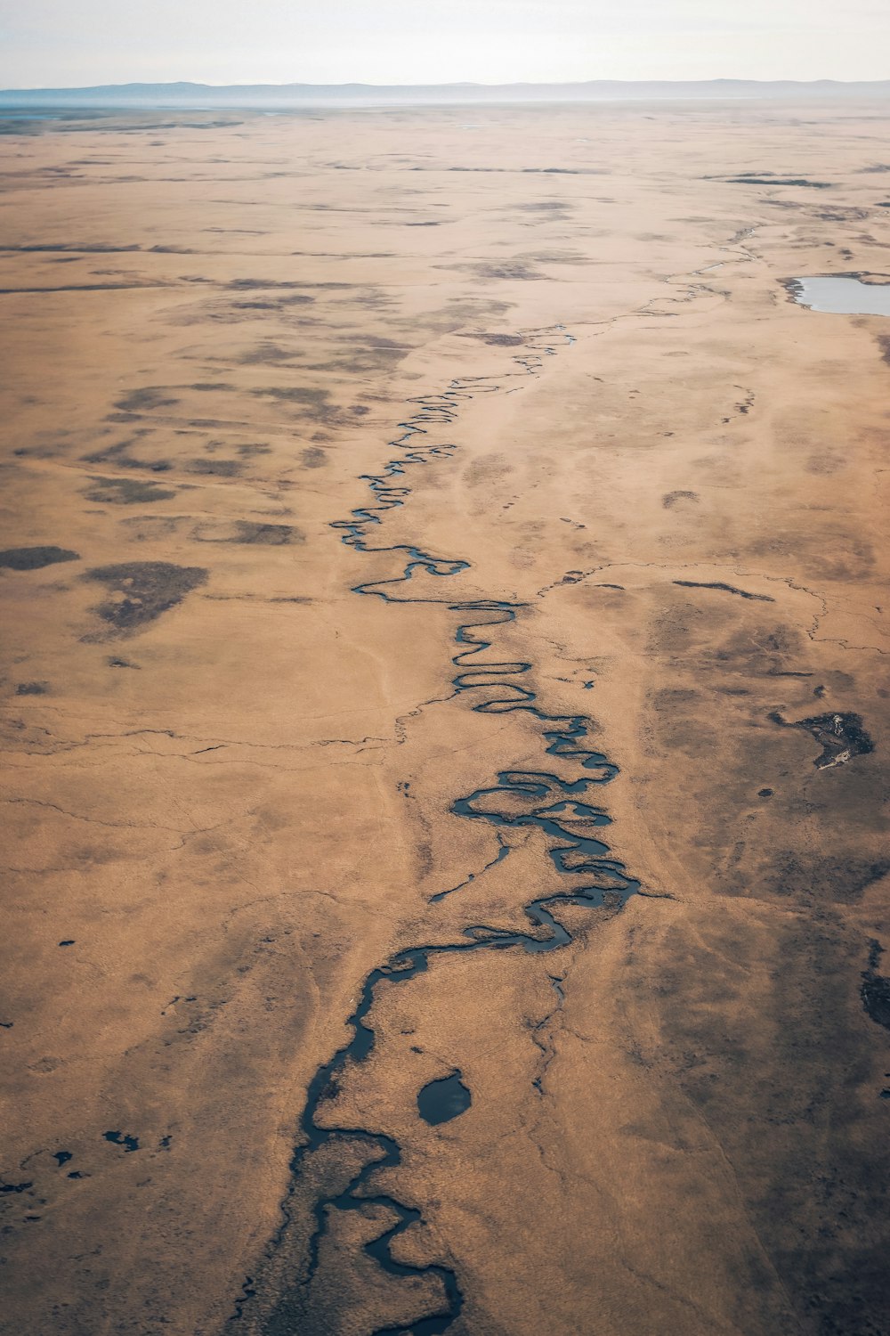 an aerial view of a river in the desert