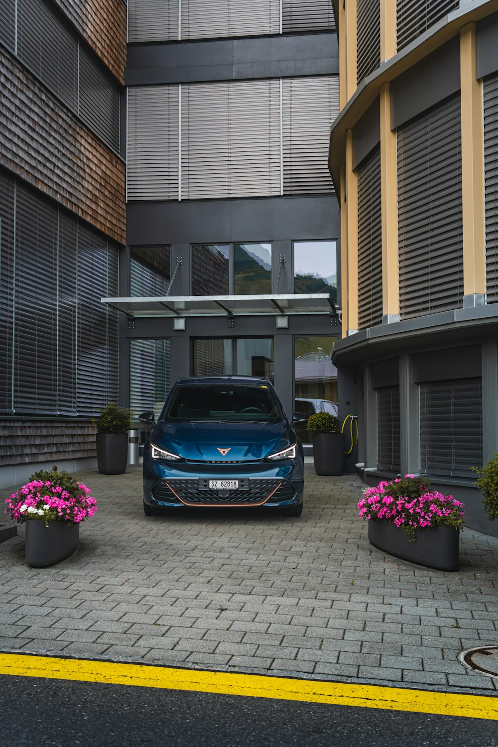 a blue car parked in front of a building