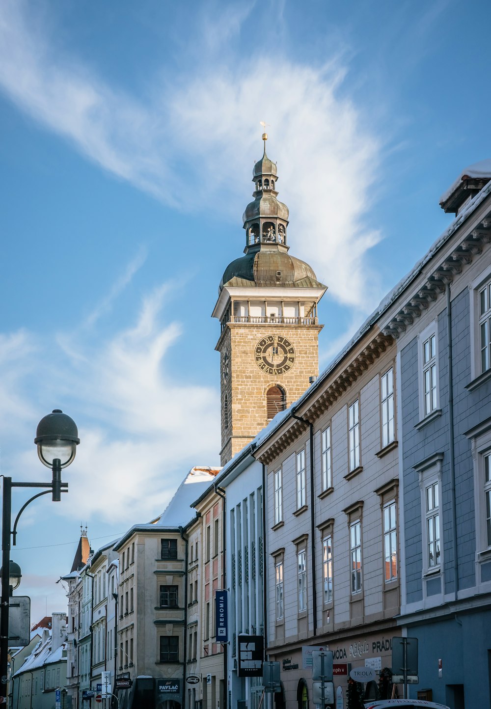 a tall clock tower towering over a city street