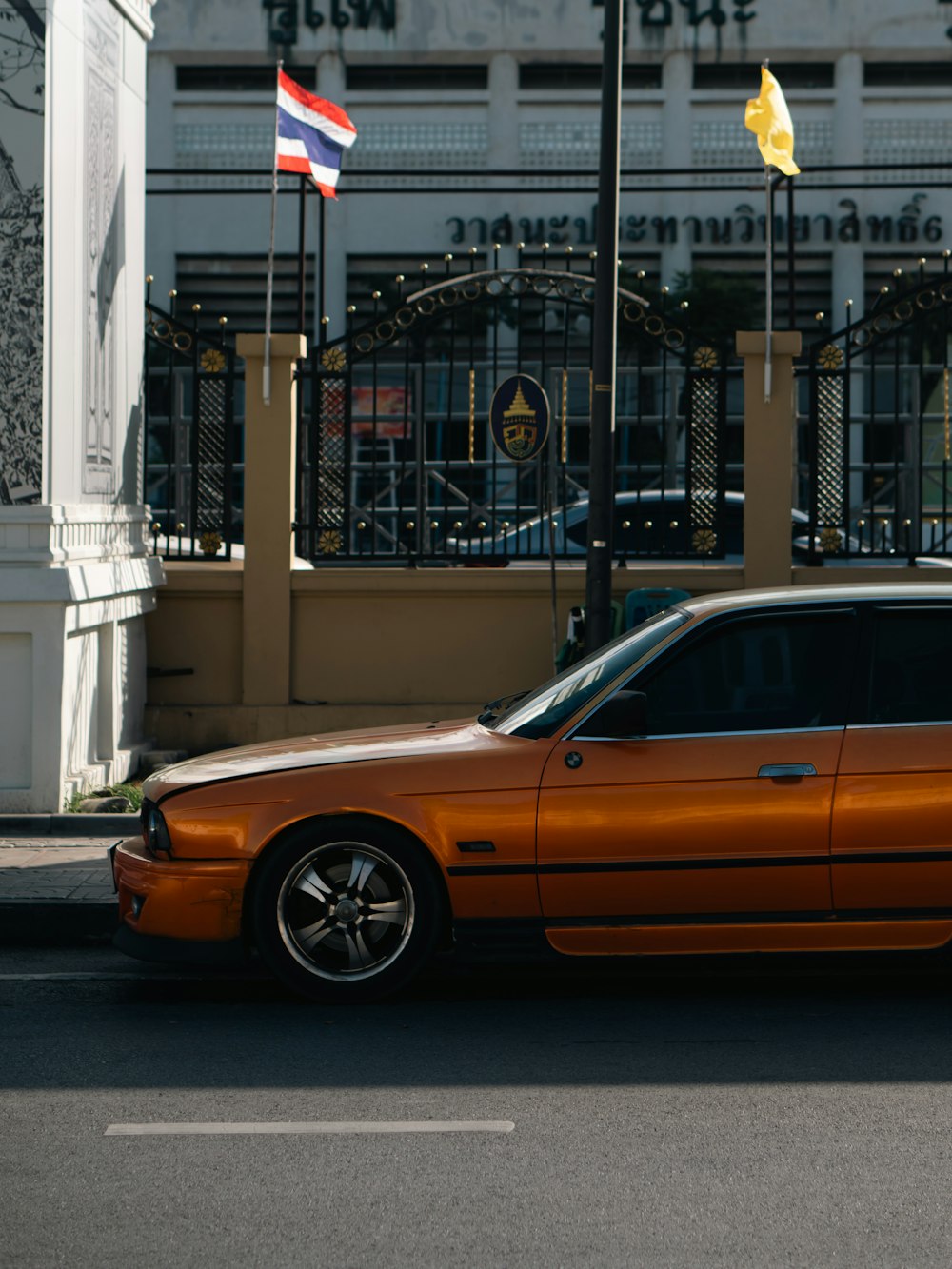 an orange car parked in front of a building