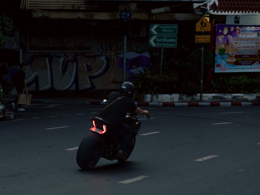 a person riding a motorcycle on a city street