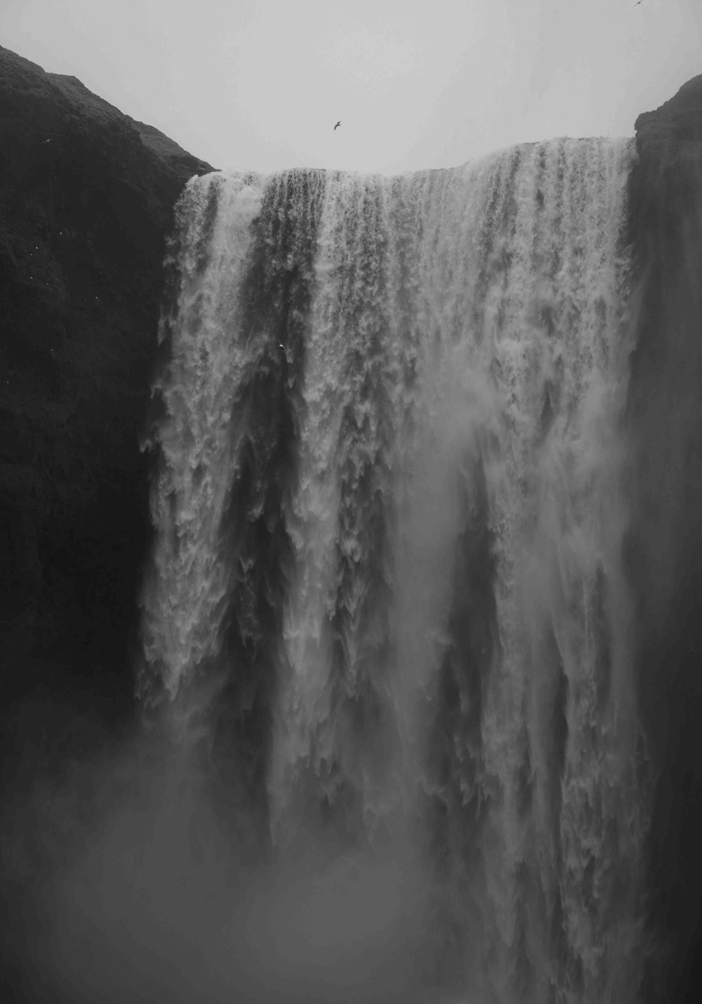 a black and white photo of a waterfall