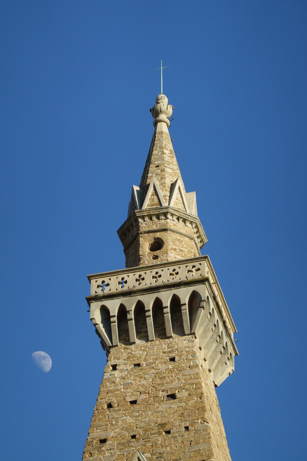 a very tall tower with a clock on it's side