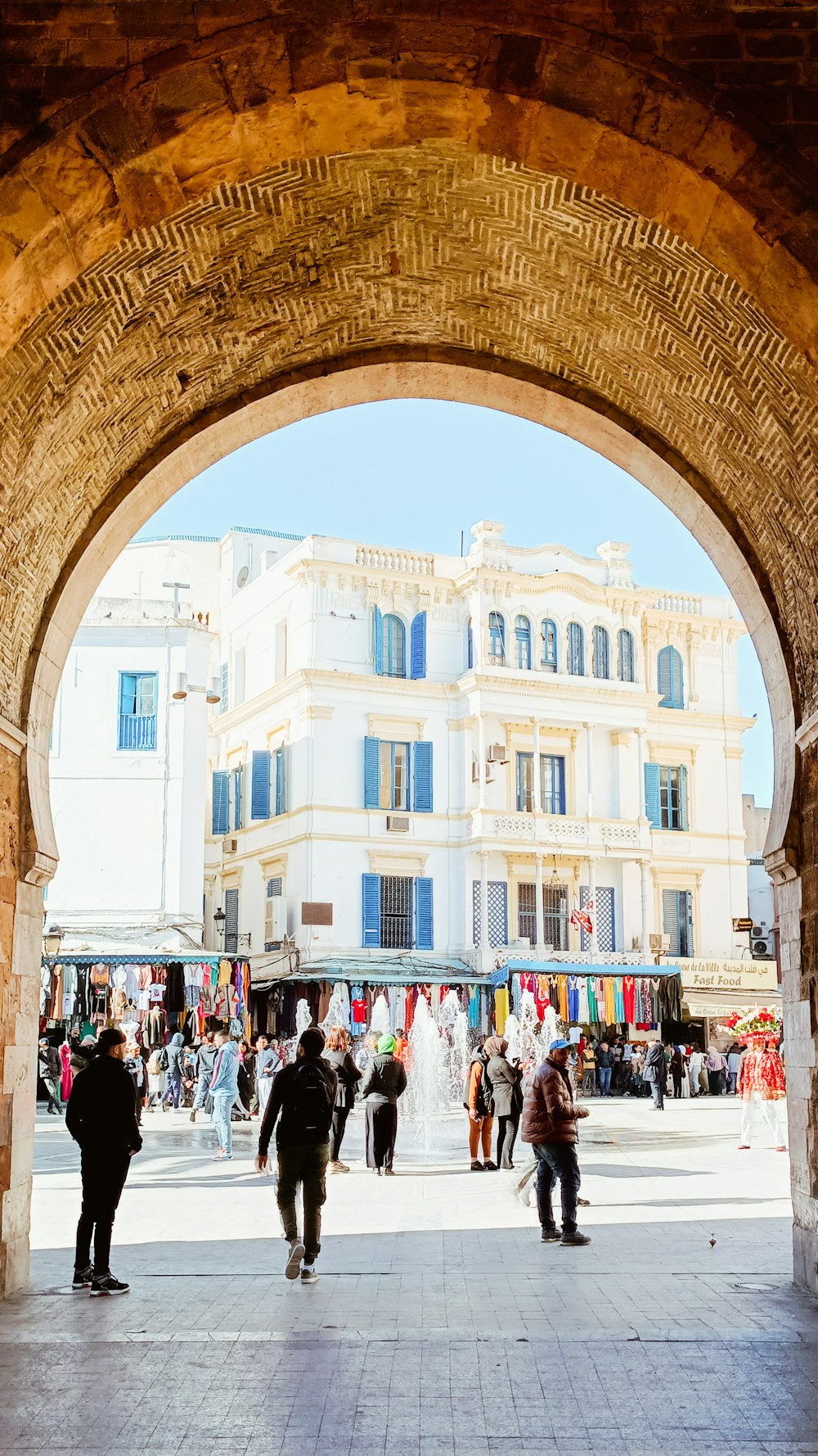 a group of people walking under an archway