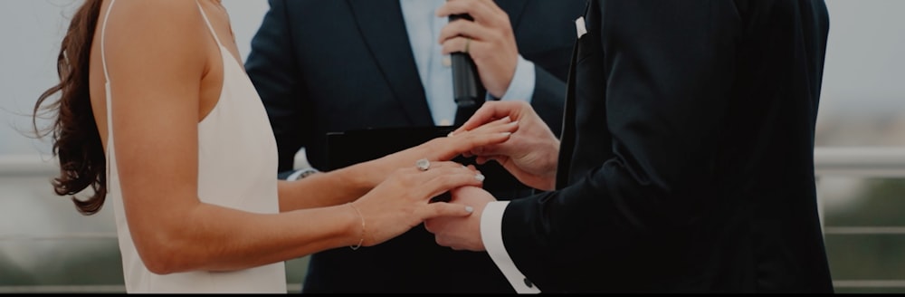 a man and woman holding hands during a wedding ceremony