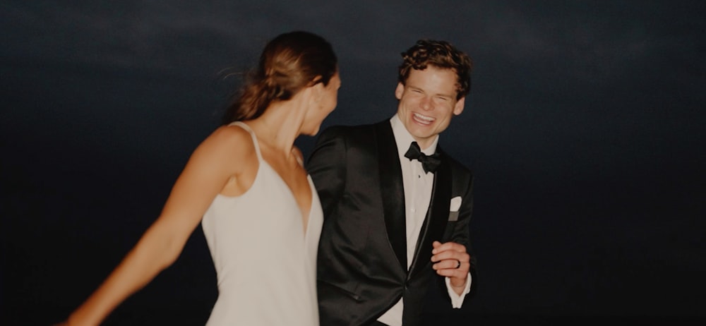 a man in a tuxedo and a woman in a white dress