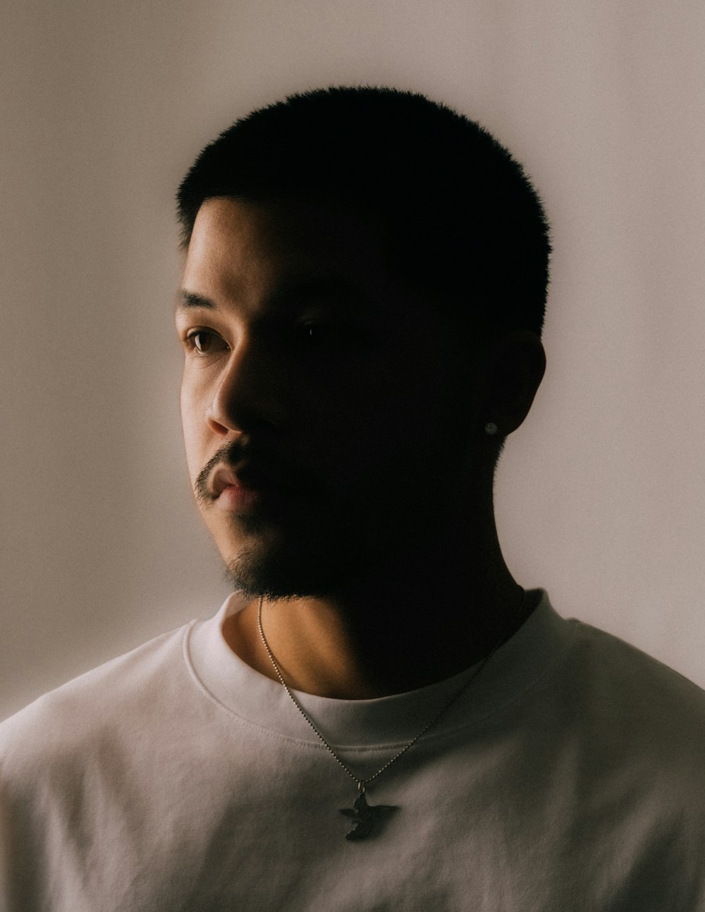 a man with a cross necklace on his neck