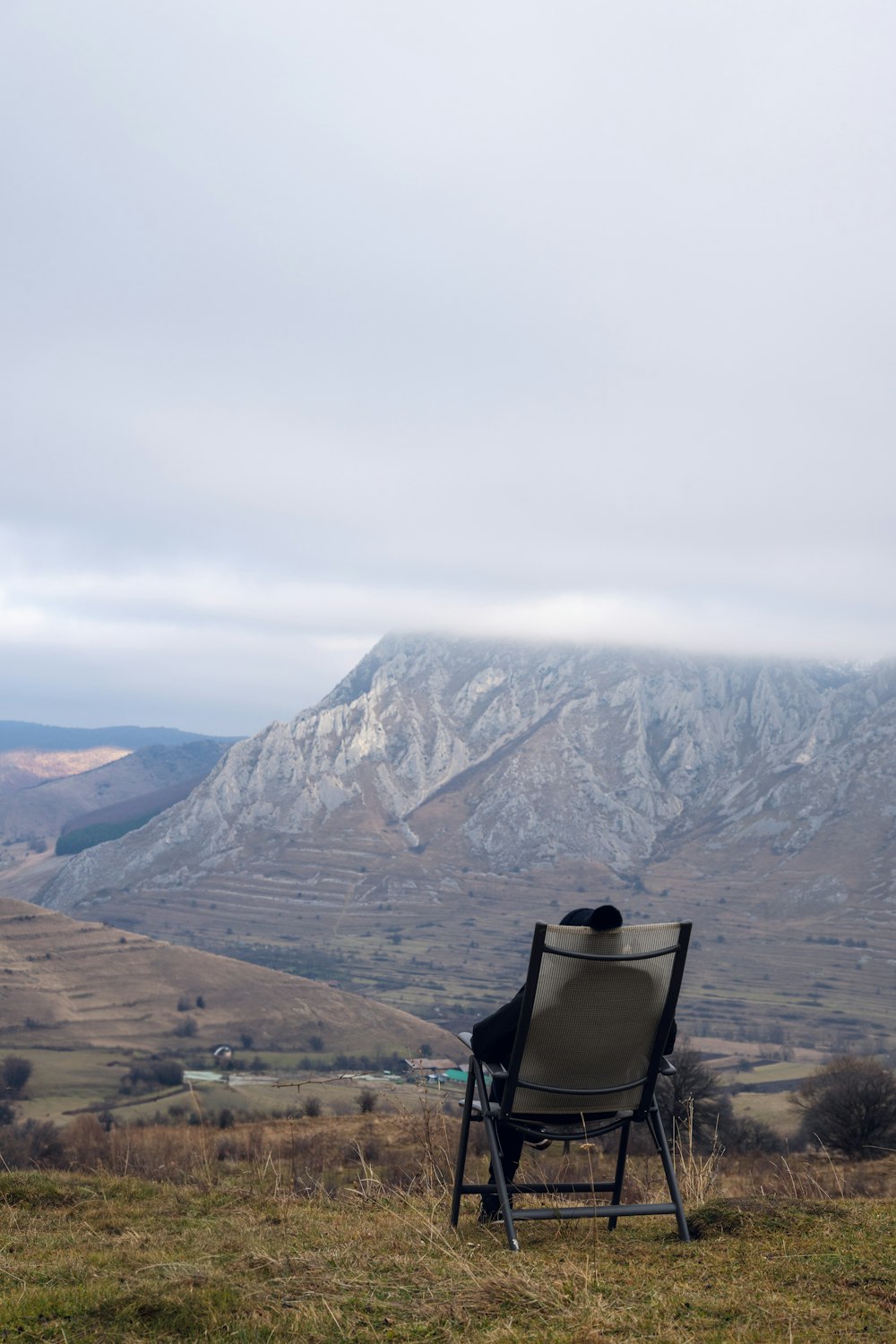 a chair sitting on top of a grass covered field