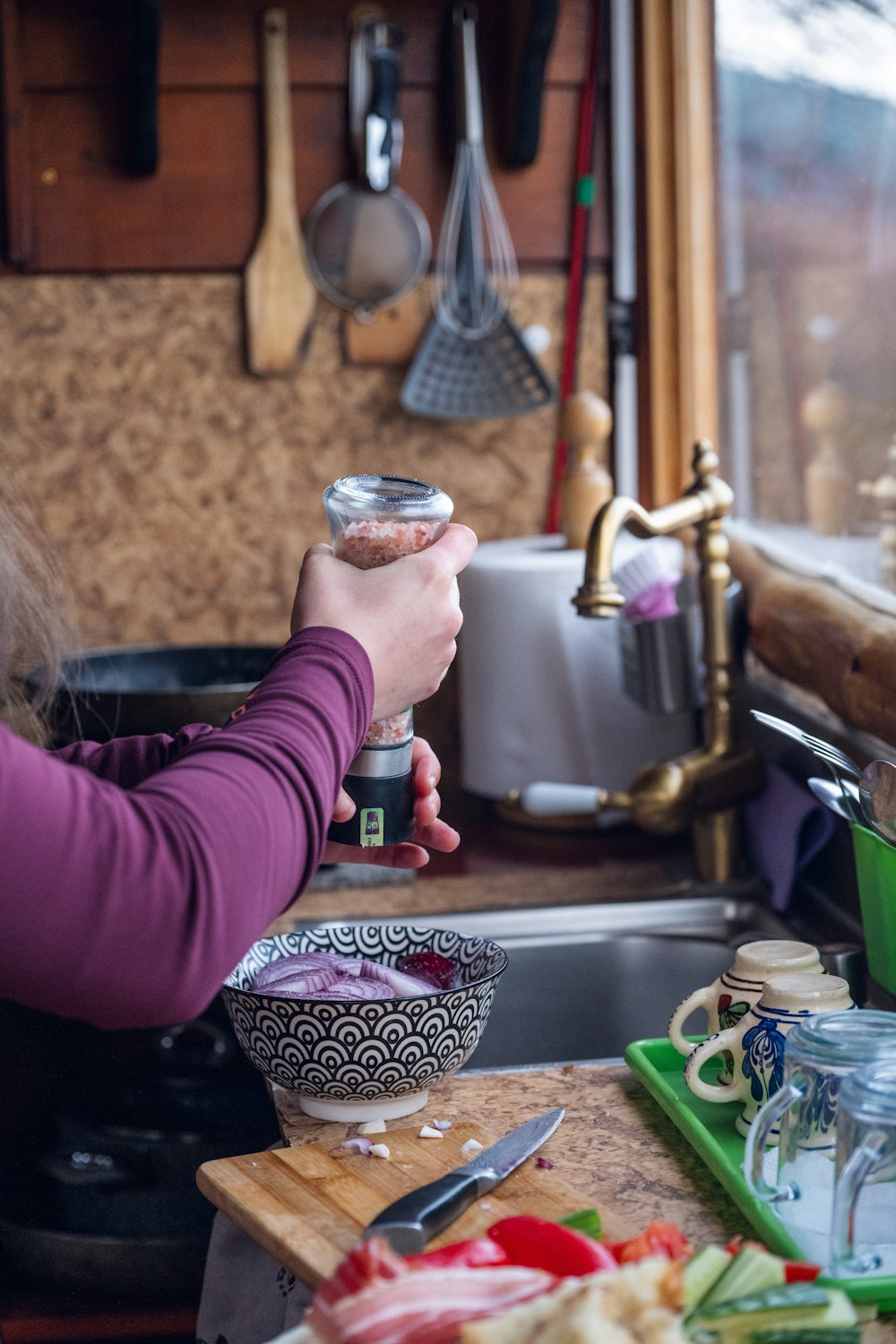 a woman is holding a can in a kitchen