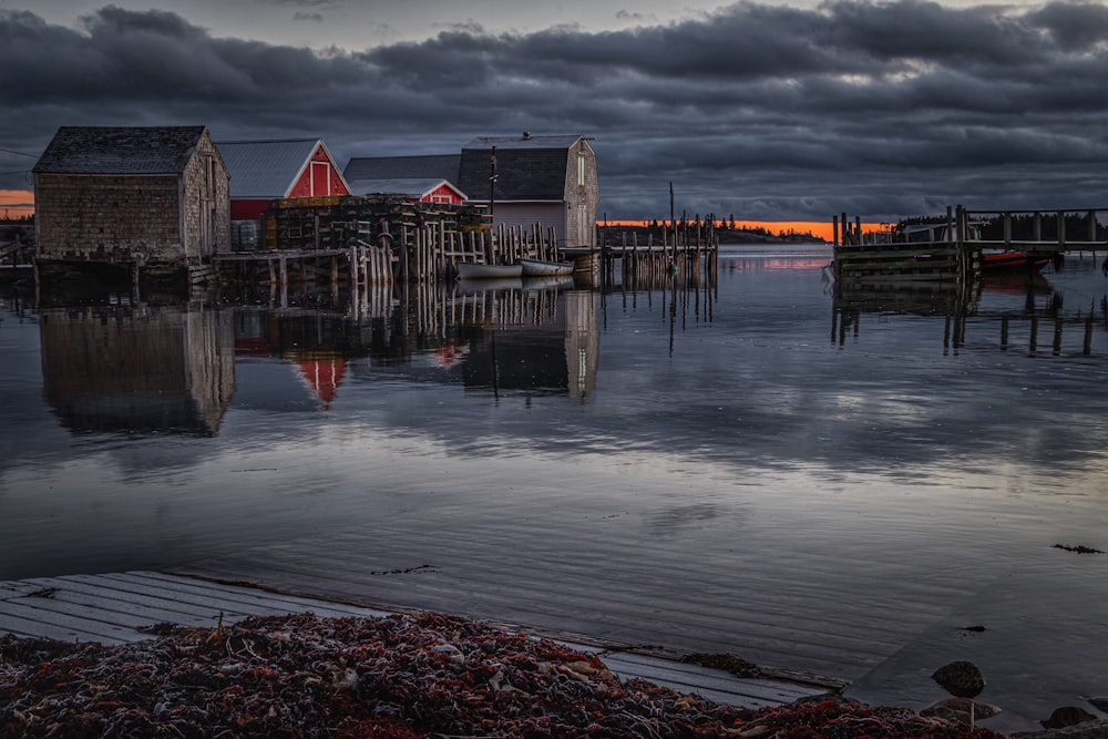 a dock with a few houses and a boat in the water