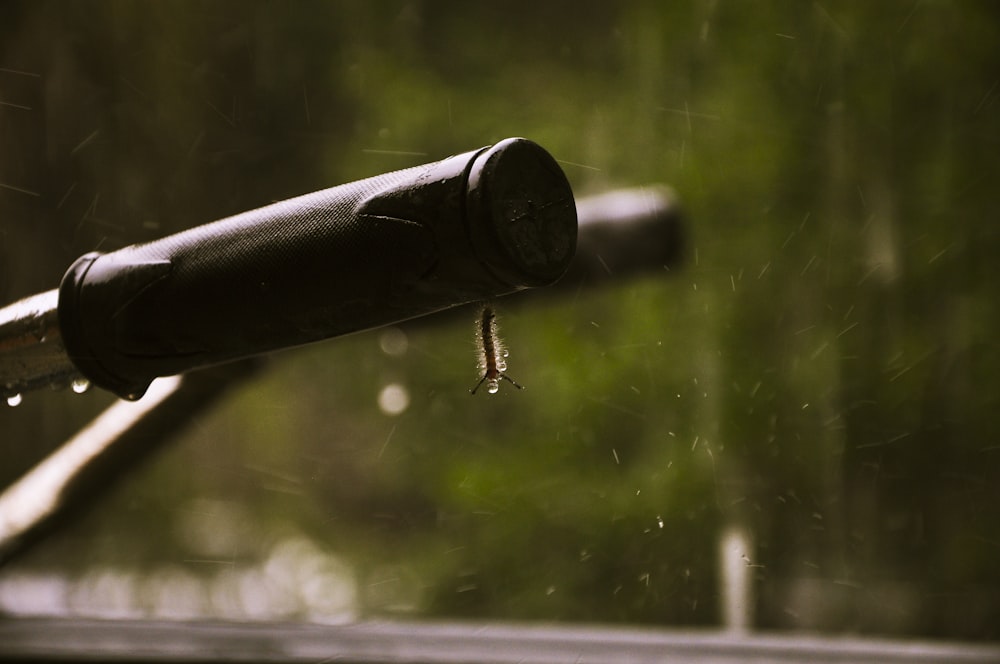 a close up of a bike handle with rain drops on it