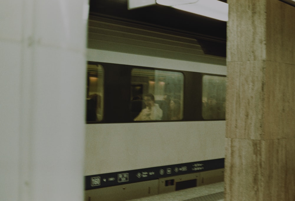 a subway train traveling down train tracks next to a platform