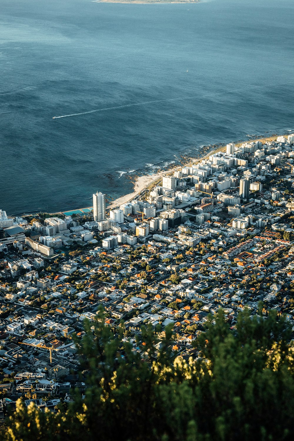 an aerial view of a city next to the ocean