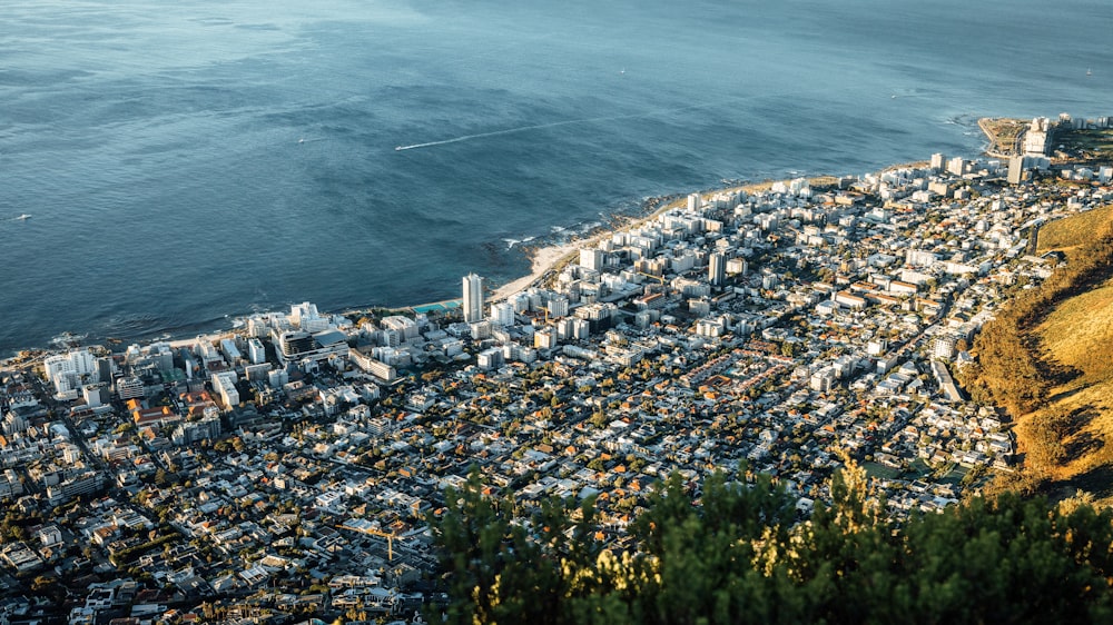 an aerial view of a city next to the ocean