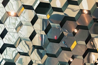 a mirrored wall with lights reflecting off of it