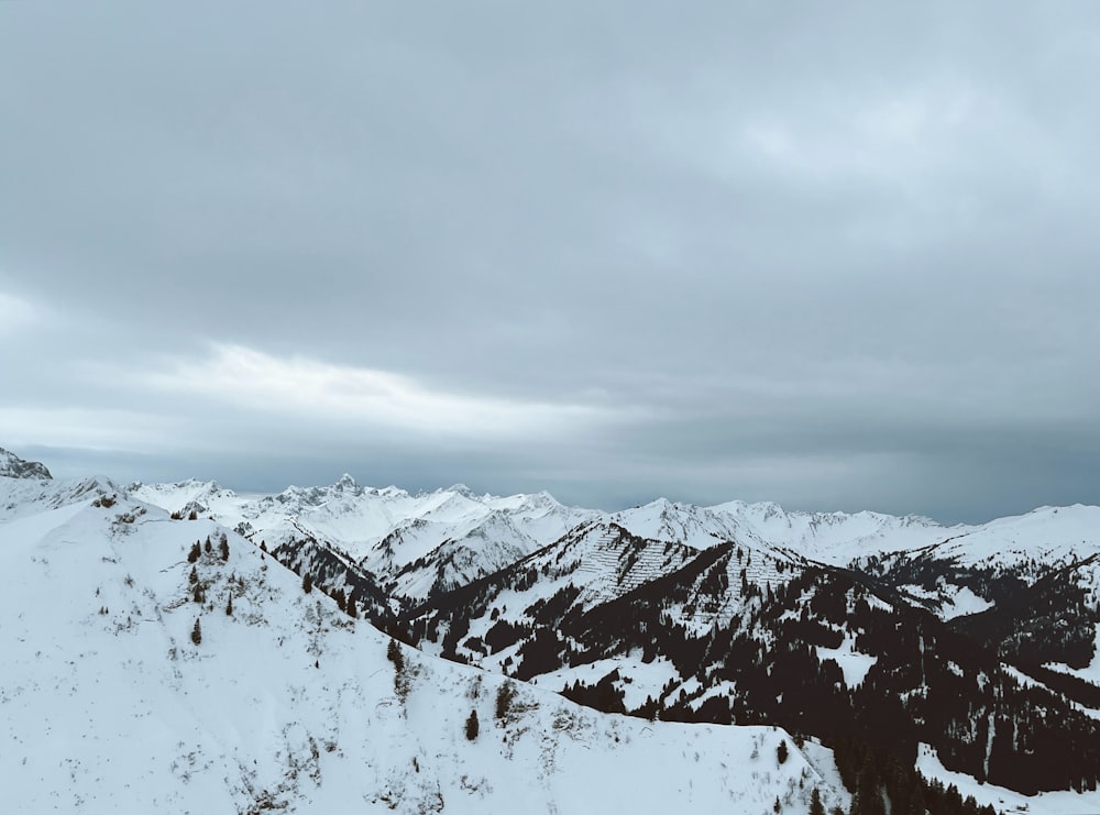 a person on a snowboard on top of a snow covered mountain