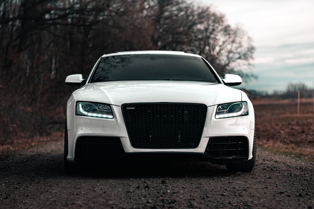 a white car parked on the side of a road