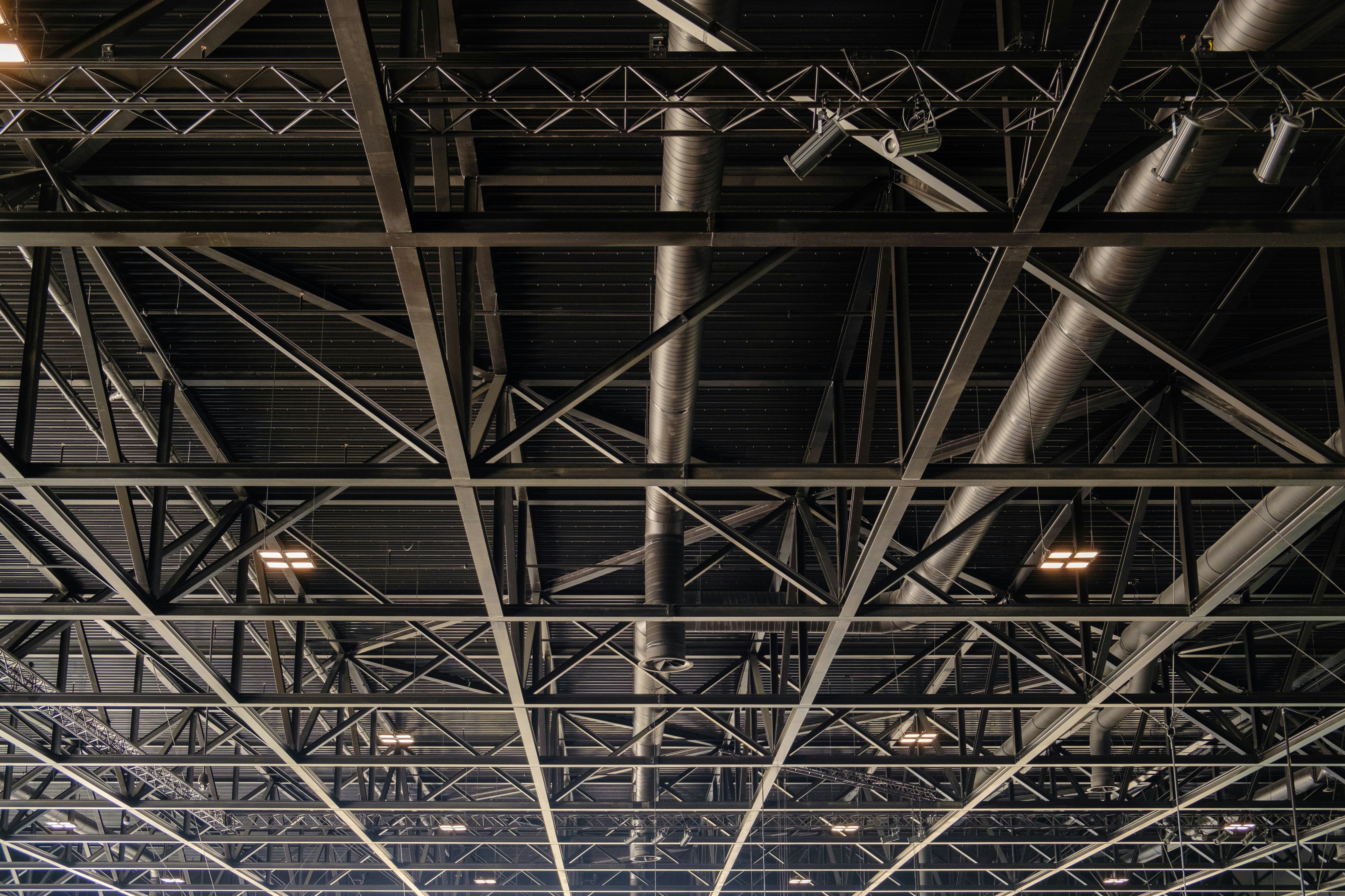 a group of people standing under a metal structure