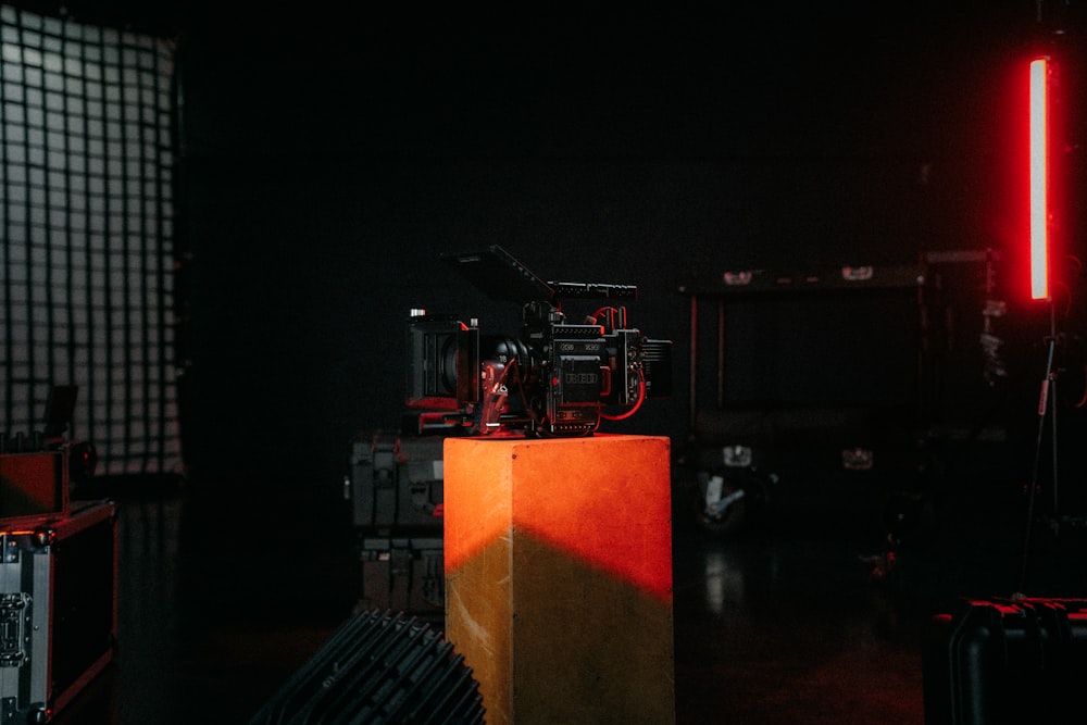 a red light shines on a camera in a dark room
