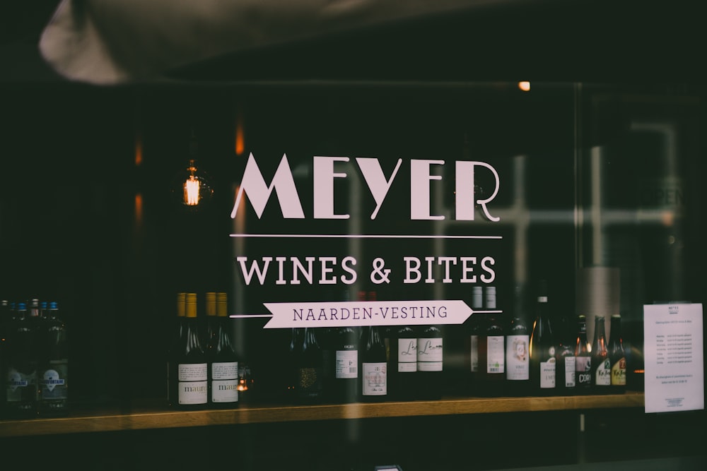 a store front with wine bottles behind glass