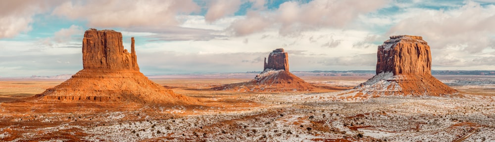 a scenic view of a desert landscape with mountains in the background