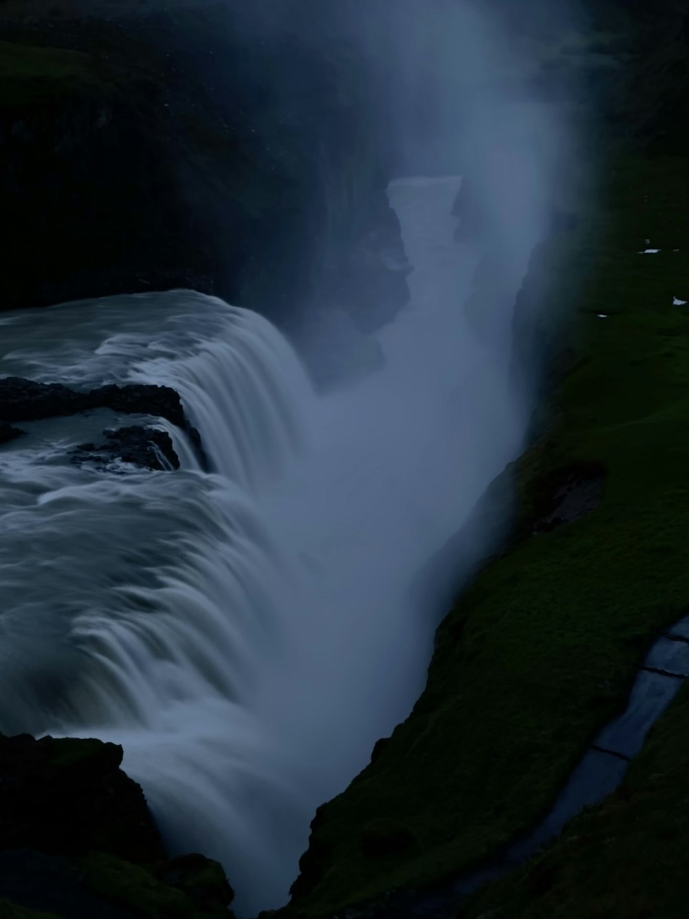 a large waterfall with water pouring out of it