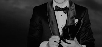 a black and white photo of a man in a tuxedo